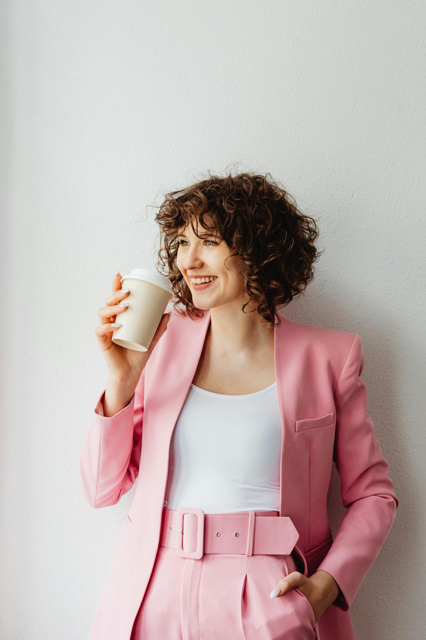Woman in Her Pink Suit Holding a Coffee